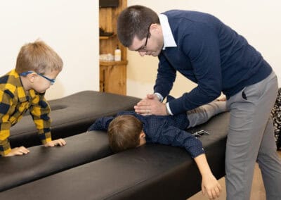 Chiropractor performing child spinal adjustment at Ignite Chiropractic.