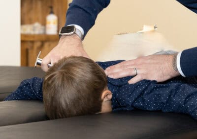 Child receiving chiropractic adjustment at Ignite Chiropractic in Fargo.