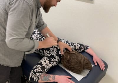 Chiropractor performing spinal adjustment on patient at Ignite Fargo.